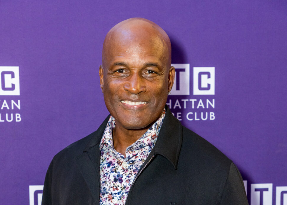 Man smiling on purple background